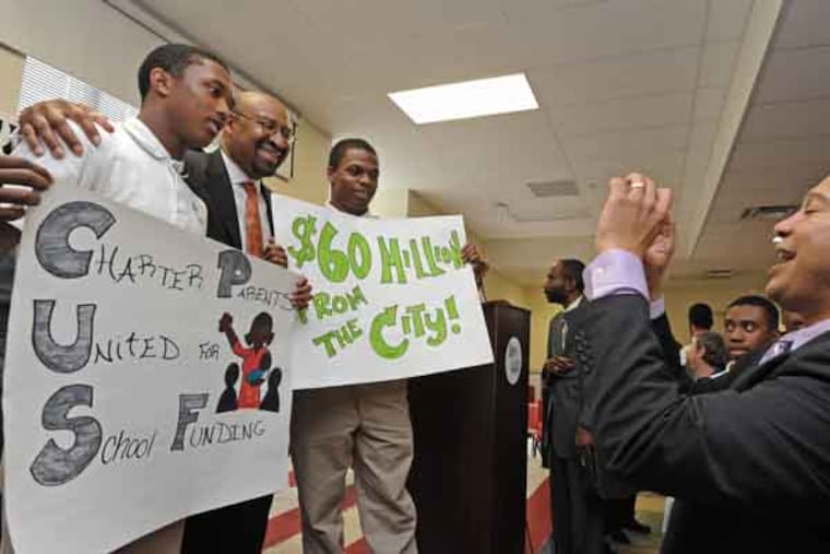 Mayor Michael Nutter, Superintendent of Schools William R. Hite, Jr. and others talk about school funding shortages on Boys Latin Charter School on 5/23/13. Here, principal Noah Tennant takes a photo of Nutter with students Siddiq Moyer, 17, left; and Emmanuel Sloan, 17/( APRIL SAUL / Staff )