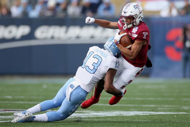 Star receiver Jadan Blue (right) is also expected to handle and punts and kickoffs for the Owls this season. Here he encounters North Carolina defensive back Don Chapman in the Military Bowl on Dec. 27, 2019.