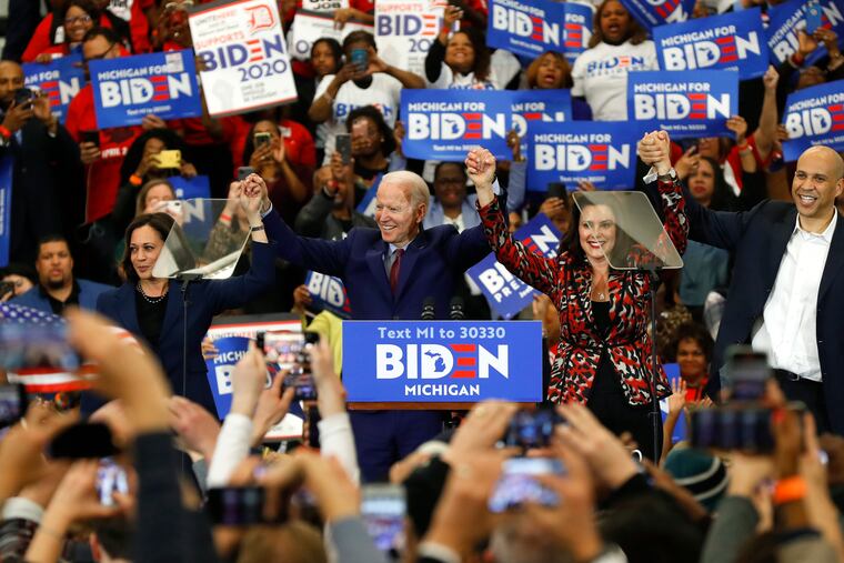 Sen. Kamala Harris, D-Calif., from left, Democratic presidential candidate former Vice President Joe Biden, Michigan Gov. Gretchen Whitmer, and Sen. Cory Booker D-N.J. greet the crowd during a campaign rally at Renaissance High School in Detroit.