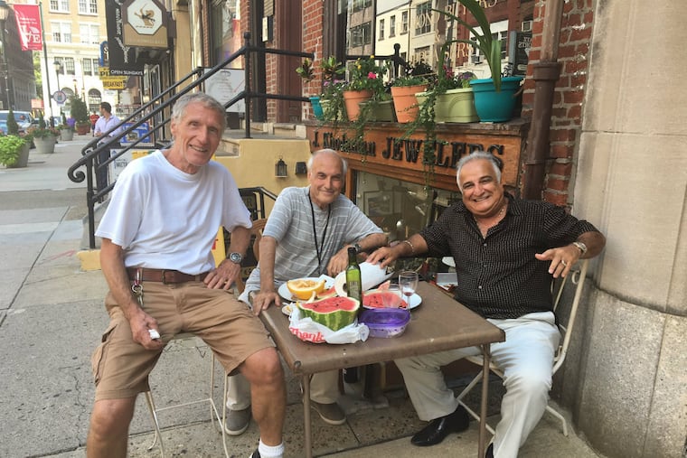 On Jewelers Row, (from left) jewelry designer Jean Huffenus and merchants John Khodandian and Reuven Cohen share a lunch on the sidewalk in front of their Sansom Street shops.