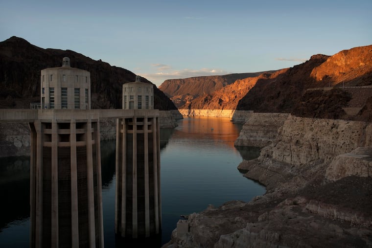 FILE - A bathtub ring of light minerals shows the high water line of Lake Mead near water intakes on the Arizona side of Hoover Dam at the Lake Mead National Recreation Area Sunday, June 26, 2022, near Boulder City, Nev.