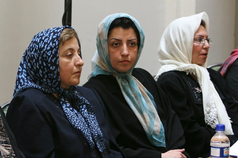 Prominent Iranian human rights activist Narges Mohammadi, center, sits next to Iranian Nobel Peace Prize laureate Shirin Ebadi, left, while attending a meeting on women's rights in Tehran, Iran, on Aug. 27, 2007.