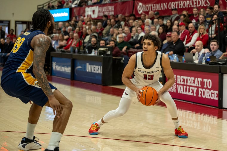 St. Joe's Austin Williford going for a three-pointer against La Salle. The Hawks accepted a bid to the National Invitational Tournament.