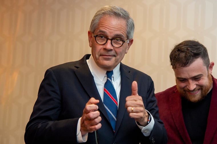 District Attorney Larry Krasner leaves the stage after his victory speech following the Democratic primary election on May 18. His son, Nate, is standing beside him.