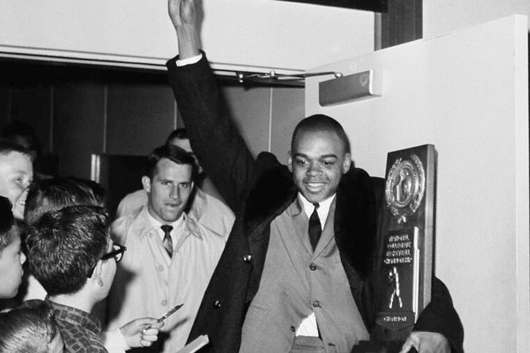 Walt Hazzard carried the trophy back to campus after helping get coach John Wooden his first NCAA title at UCLA in 1964.