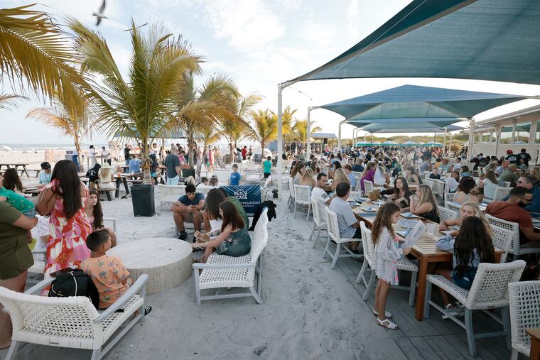 People coming in from the beach can relax and enjoy drinks (left) or be served dinner (right) at LaScala's Beach House in Brigantine, N.J.