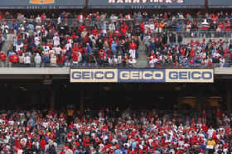 Fans turn toward the giant video screen in left field at Citizens Bank Park to viewan image of the Phillies' diamond-studded World Series ring.
