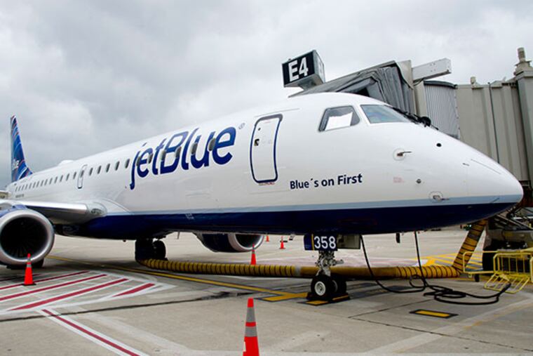 A JetBlue plane sits at the gate at Philadelphia International Airport May 23, 2013 after arriving from Boston's Logan Airport to start the company's service in Philadelphia. The plane is a new Embraer 190, made in Brazil. ( CLEM MURRAY / Staff Photographer )