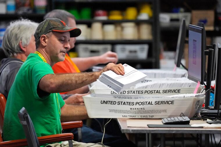 Allegheny County workers scan mail-in and absentee ballots at the Allegheny County Election Division Elections warehouse in Pittsburgh in 2022.