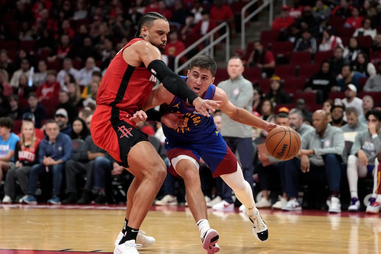 Denver Nuggets point guard Collin Gillespie is defended by Houston's Dillon Brooks on Nov. 12.