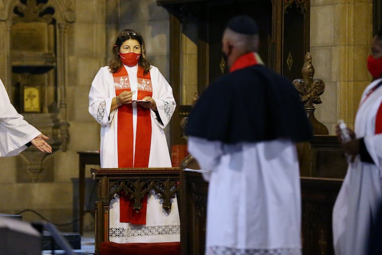 Rev. Yesenia "Jessie" Alejandro offers Communion during her ordination ceremony at St. John's Episcopal Church in Norristown on Saturday.