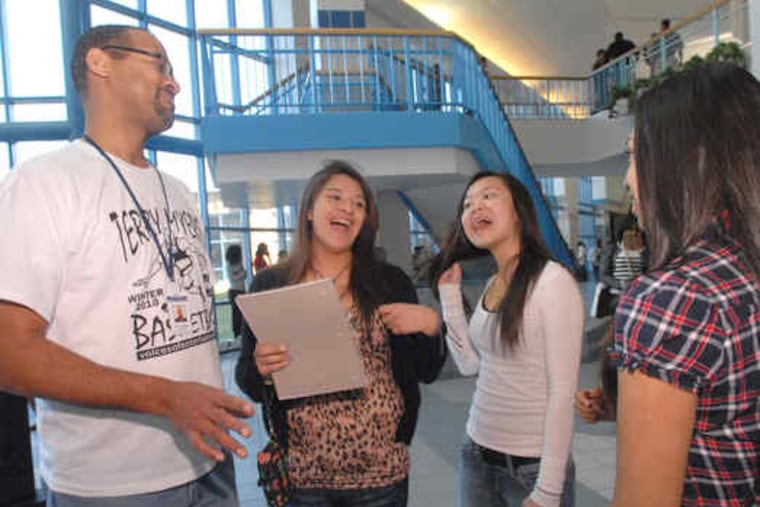 Atlantic City High math teacher Don Coleman jokes between periods with students (from left) Andrea Gudino, 15; Shakyee Chan, 14; and Kelsey Avila, 14. School will be in session two more Saturdays, a solution deemed preferable to a reduced spring break. Classes were shortened from 40 minutes to 22.