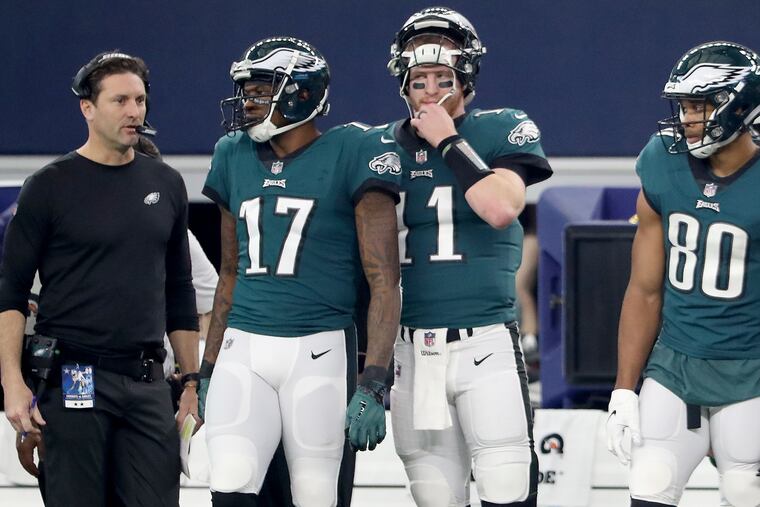 Left to right: EaglesÕ offensive coordinator Mike Groh, Eagles wide receiver Alshon Jeffery, Eagles quarterback Carson Wentz, and Eagles wide receiver Jordan Matthews wait on the sideline during the 1st quarter against the Cowboys. Philadelphia Eagles play the Dallas Cowboys in Arlington, TX on December 9, 2018. DAVID MAIALETTI / Staff Photographer