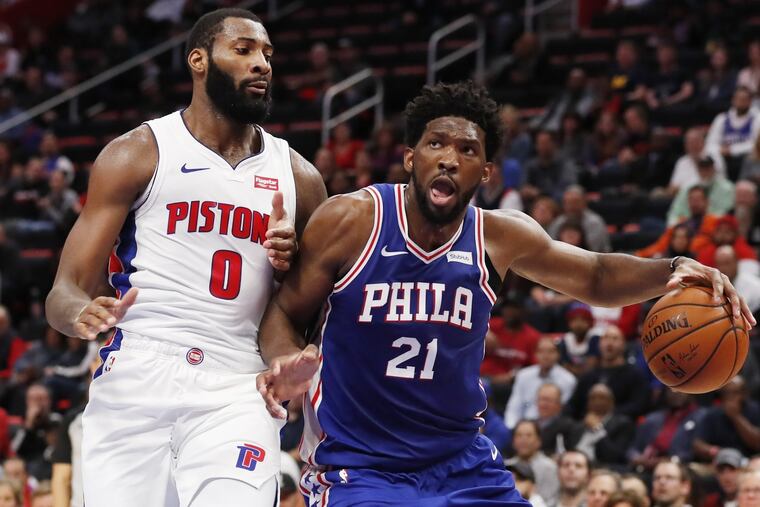 76ers center Joel Embiid drives on Detroit Pistons center Andre Drummond during a game earlier this season.