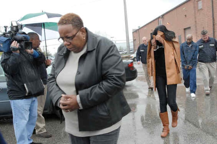 One of the defendants, Gail Polk, leaves Attorney General Tom Corbett's office in Philadelphia. The others are Mikiba Carter, Takarra Scott, Crystal Gray, Melvin Jones, and Tasha Riddick.