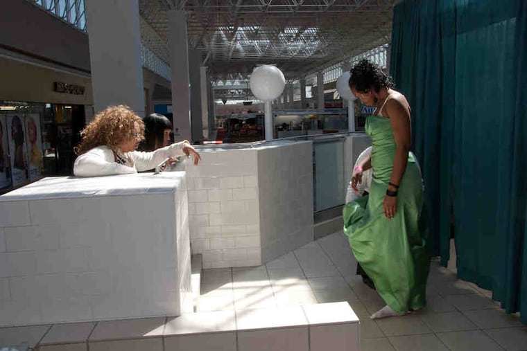 Erica Adeleye from Mastery Charter School poses for her aunt. Fairy Godmothers sells new gowns for $10, shoes for $5, accessories for $2.