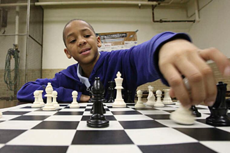STEVEN M. FALK / STAFF PHOTOGRAPHER Nifese Hopkins has checkmate on his mind as a member of the Mitchell Elementary chess team. A group of local student players are looking to compete in a national tournament in April.
