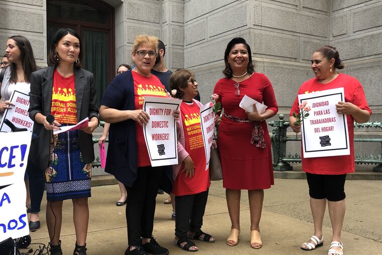 Councilwoman Maria D. Quinones-Sanchez, second from right, stands with Philadelphia domestic workers and members of the Pennsylvania Domestic Workers Alliance outside City Hall on Thursday morning. The councilwoman is the prime sponsor of legislation aimed at increasing labor protections for domestic workers like nannies and house cleaners.