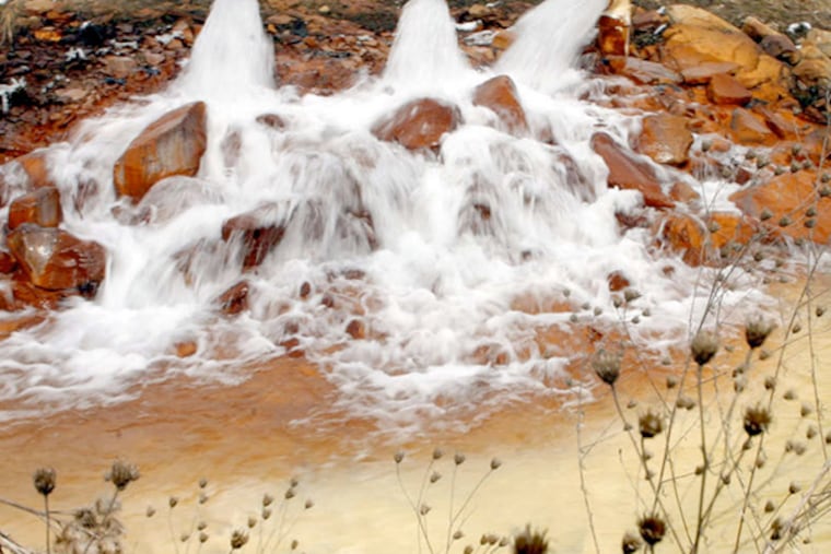 Runoff from flooded underground coal mines pours into Saxman Run in Latrobe, Pa. A bill would allow such water in fracking.