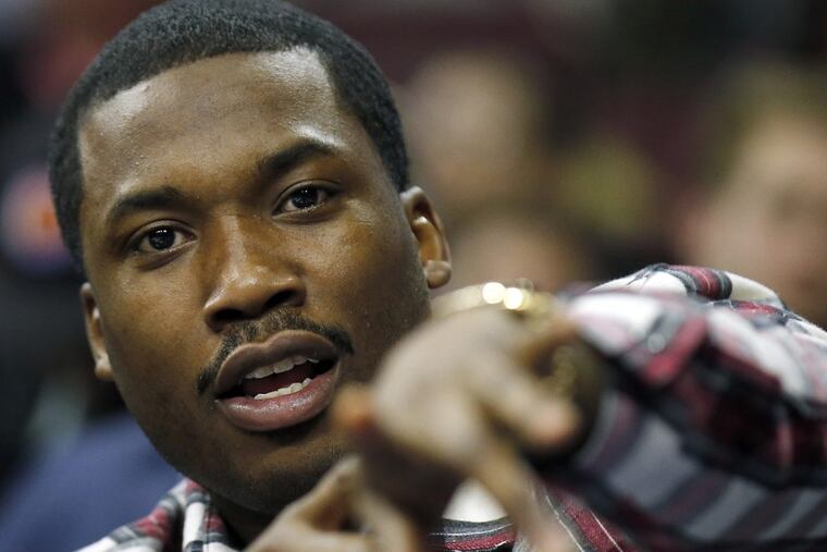Hip-hop artist Meek Mill attends as the Philadelphia 76ers play host to the Sacramento Kings on February 10, 2016, at the Wells Fargo Center in Philadelphia. Despite serving a 2- to 4-year prison term for violating the terms of his 10-year-old probation, Mill’s team will still give away turkeys.