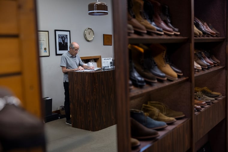 Bruce Rubin conducts bookkeeping at Sherman Brothers Shoes in Center City. Rubin has worked for the family business, which is moving to Ardmore this summer, since he was 16.