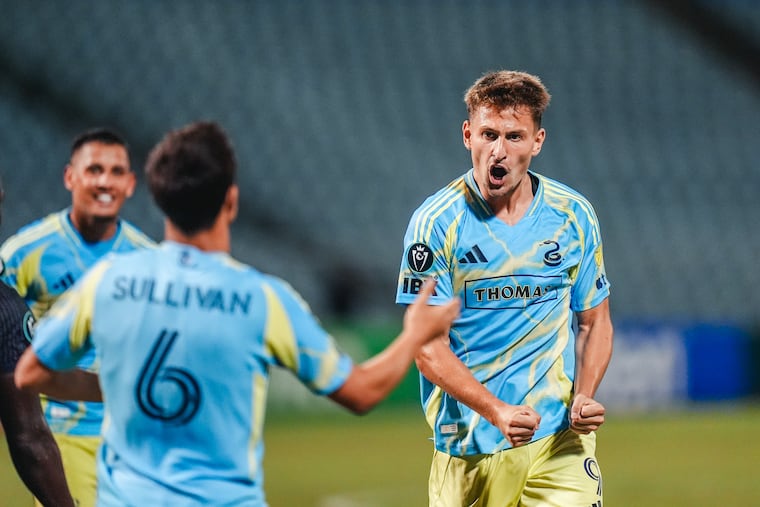 Bruno Damiani (right) celebrates with Cavan Sullivan after scoring one of his two goals in the Union's 5-0 rout of Defence Force FC on Wednesday night.