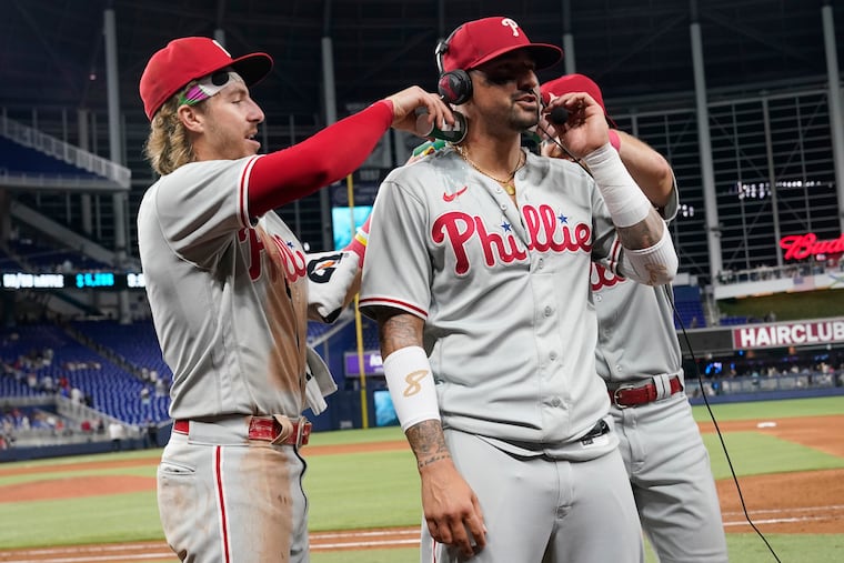 Bryson Stott pours water on Phillies right fielder Nick Castellanos as he is interviewed after his decisive home run in the ninth inning Tuesday.