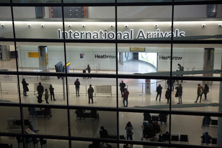 This Jan. 26 photo shows people in the International Arrivals area at Heathrow Airport in London.