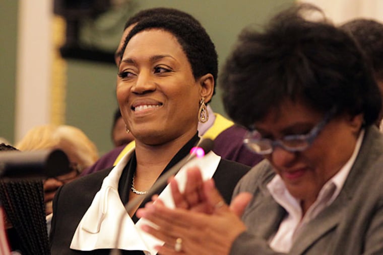 Jacquelyn Frazier-Lyde, left, smiles as city councilwoman Jannie Blackwell, right, reads a city proclamation in her honor as she was being inducted into the Pennsylvania Boxing Hall of Fame in Philadelphia on May 1, 2014. (David Maialetti/Staff Photographer)