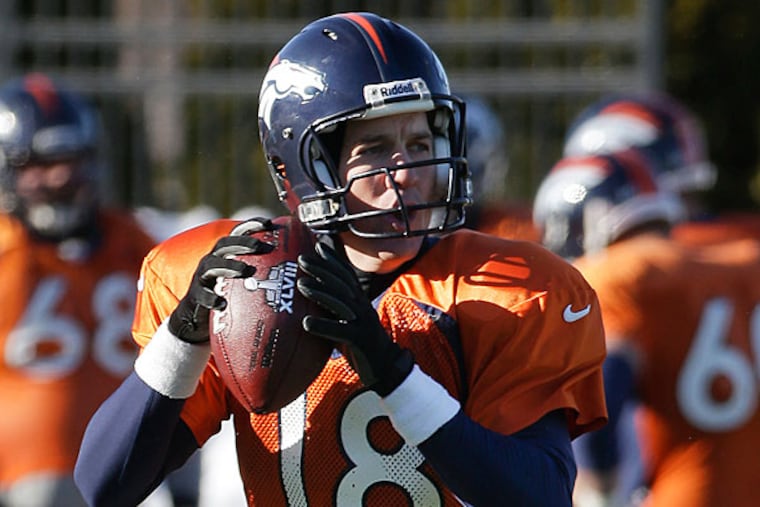 Broncos quarterback Peyton Manning (18) passes during practice Wednesday, Jan. 29, 2014, in Florham Park, N.J. The Broncos are scheduled to play the Seattle Seahawks in the NFL Super Bowl XLVIII football game Sunday, Feb. 2, in East Rutherford, N.J. (Mark Humphrey/AP)
