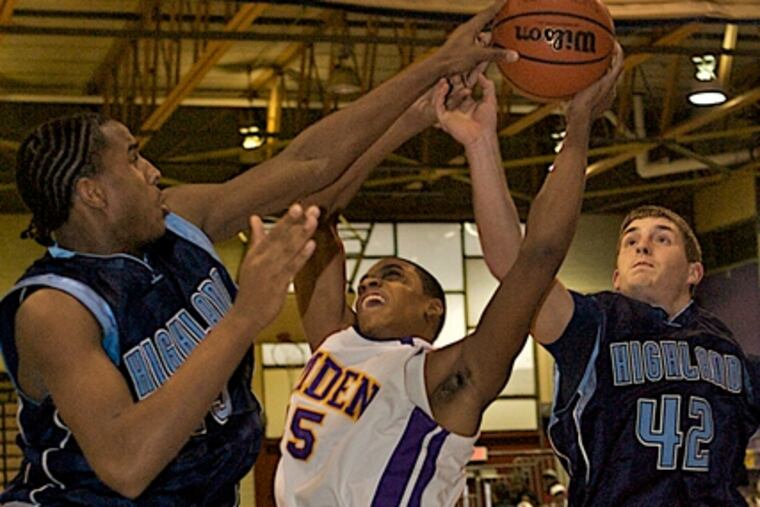 Highland's Sean Daniels blocks a shot by Camden's Tarrell Harper as teammate Tedd Teschner helps out. Daniels is among the area's stronger inside players.