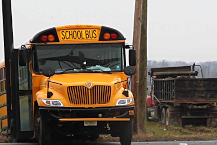 An 11-year-old triplet was killed, and her two sisters and another boy were critically injured, Thursday morning when a dump truck (right) slammed into their school bus in rural Burlington County. (David M. Warren / Staff Photographer)