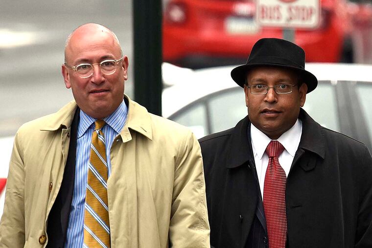 Tyron B. Ali, right, along with attorney Alan J.Tauber, left, arrive at the Dauphin County Court house for a hearing Monday, March 28, 2016 in Harrisburg, Pa.