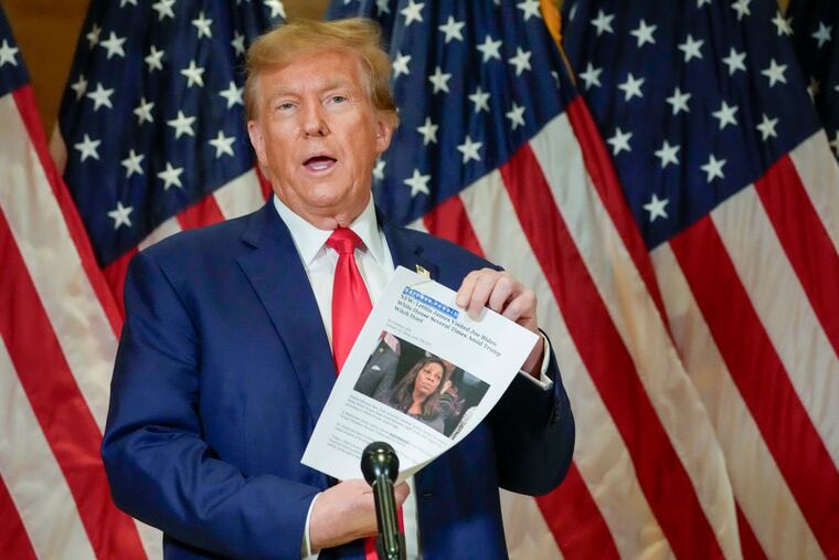 Former President Donald Trump holds up a copy of a story featuring New York Attorney General Letitia James while speaking during a news conference in January in New York.