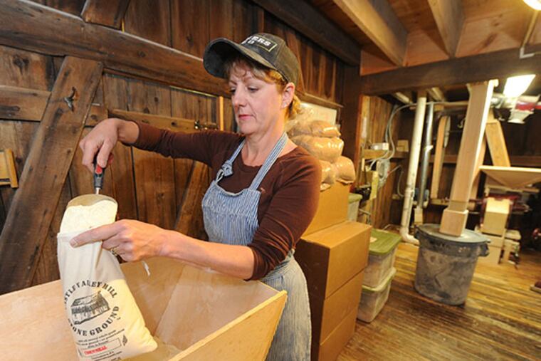 Fran Fischer, packages cornmeall into 2lb. bags at Castle Valley Mill. Fischer and her husband, Mark, are reviving the mill to produce artisan flours and other products for sale to restaurants, bakeries and stores. The mill and property, which dates to the 1700s, was purchased by Mark's grandfather back in the 1940s. ( CLEM MURRAY / Staff Photographer )