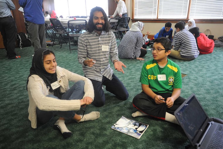 SMUSLIMYOUTH20PA 3-19-17 Islamic Society Of Chester County,1001 Pottstown Pike,West Chester, pa: Seminar to teach skills to cope against bullying against Muslim Children. Approx.30 children from area schools and the region participated. The adult moderator was Ishaq Pathan (cq) of Newark, California.Left to right Amira Elqorchi (cq) age 12 of West Chester listens to moderator Ishaq Pathan (cq) as Amaan Syed (cq) age 12 of Downingtown looks on. 1of8.
