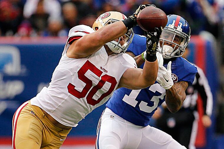 49ers inside linebacker Chris Borland intercepts a pass intended for Giants wide receiver Odell Beckham. (John Munson/NJ Advance Media for NJ.com via USA TODAY Sports)