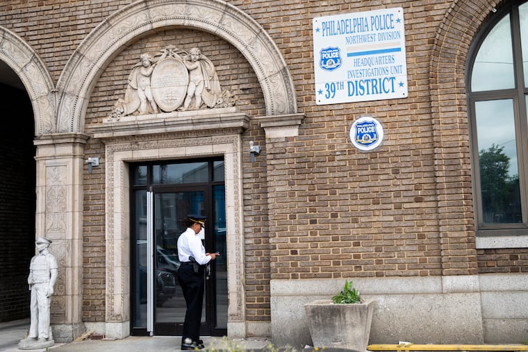 A Philadelphia Police Officer arrives at the entrance at the 39th District Headquarters in May.
