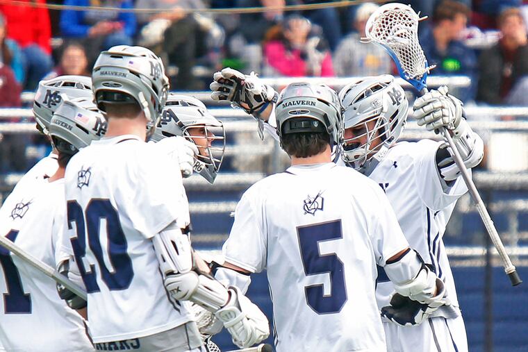 Malvern Prep's Billy Coyle (right) celebrates his game-winning goal against Garnet Valley with teammates, including A.J. Traynor (1), Quinn McCahon (20) and Mike Fay (5). Coyle's score with 2.9 seconds remaining gave the Friars an 11-10 victory in a nonleague lacrosse game.