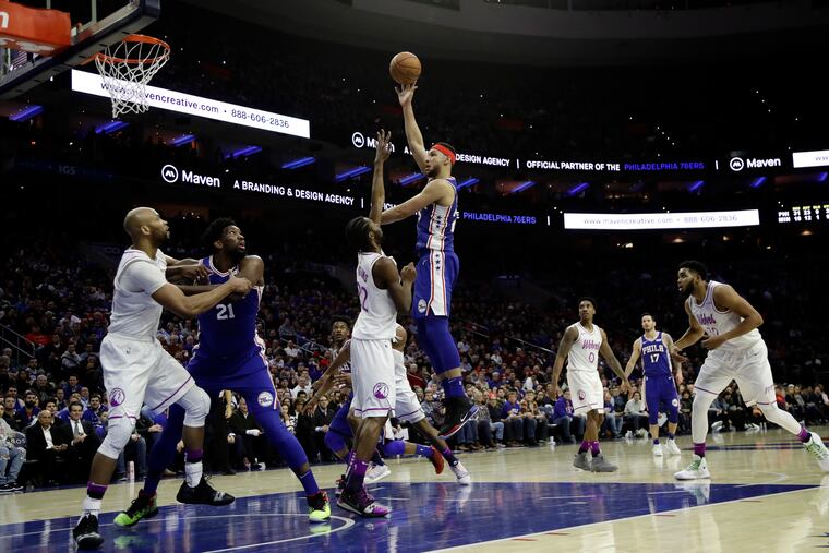 Sixers point guard Ben Simmons puts up a shot over Timberwolves wing Andrew Wiggins on Tuesday.