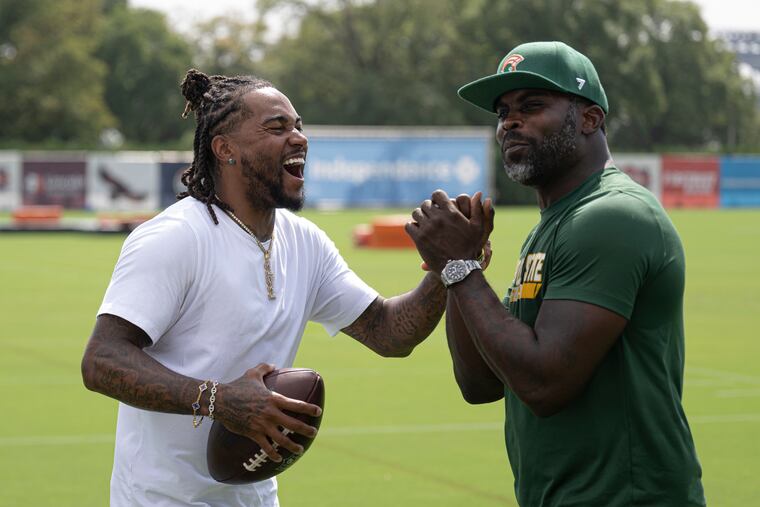 Former Eagles stars DeSean Jackson (left) and Michael Vick paid a visit to training camp this summer ahead of their first matchup as college coaches.