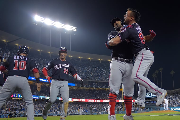 Nationals center fielder Gerardo Parra, right, greets Howie Kendrick after Kendrick hit the game-winning grand slam in the 10th inning of the National League Division Series Game 5 against the Dodgers in Los Angeles on Wednesday night.