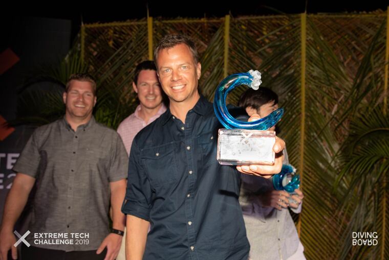 Tango cofounder Drew Lakatos hoists the trophy as winner of the Extreme Tech Challenge on Sir Richard Branson's Necker Island in April.