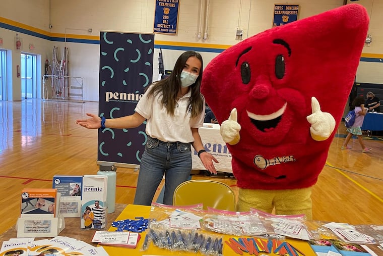 O'Liver, the Hepatitis B Foundation's mascot, hands out information about hepatitis B at a community event.