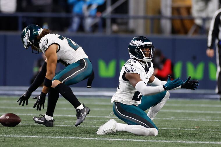 Eagles cornerback James Bradberry reacts after a pass interference penalty as teammate safety Sydney Brown goes after the loose football against the Seattle Seahawks at Lumen Field in Seattle on Monday, December 18, 2023.