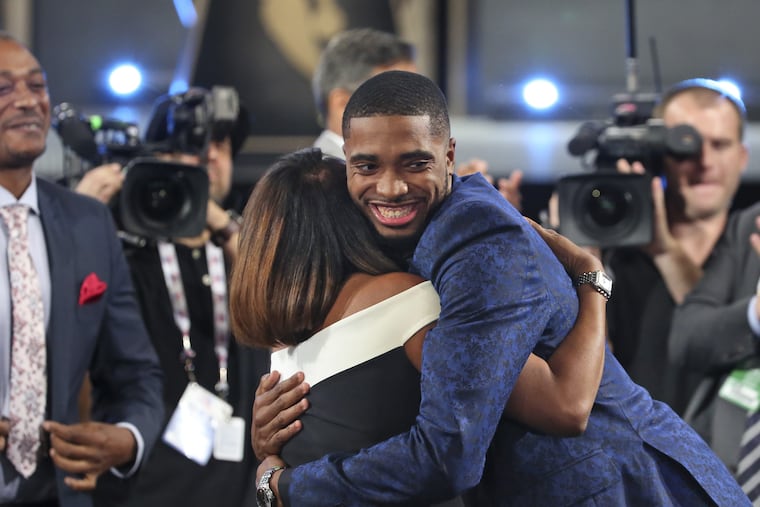 Villanova's Mikal Bridges is greeted by friends and family after he was picked 10th overall by the Philadelphia 76ers during the first round of the NBA basketball draft in New York, Thursday, June 21, 2018.
