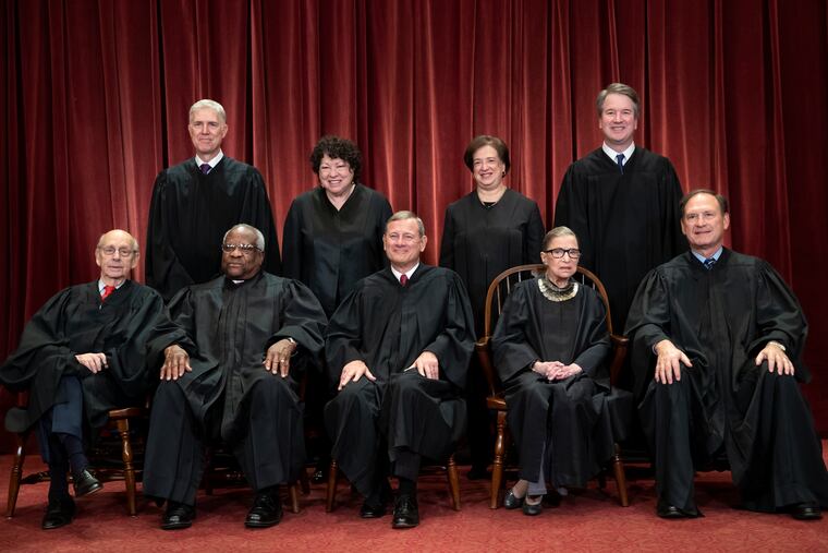 FILE - In this Nov. 30, 2018, file photo, tThe justices of the U.S. Supreme Court gather for a formal group portrait to include the new Associate Justice, top row, far right, at the Supreme Court Building in Washington, Friday, Nov. 30, 2018. Seated from left: Associate Justice Stephen Breyer, Associate Justice Clarence Thomas, Chief Justice of the United States John G. Roberts, Associate Justice Ruth Bader Ginsburg and Associate Justice Samuel Alito Jr. Standing behind from left: Associate Justice Neil Gorsuch, Associate Justice Sonia Sotomayor, Associate Justice Elena Kagan and Associate Justice Brett M. Kavanaugh. The Supreme Court announced Aug. 23, 2019, that Ginsburg has been treated for a malignant tumor. (AP Photo/J. Scott Applewhite, File)
