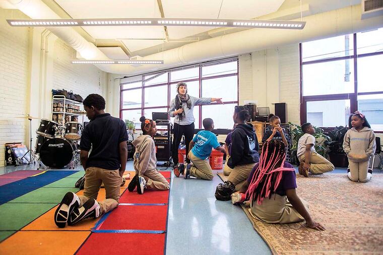 Music teacher Annie Givler directs fourth graders as they rehearse for “The Wiz” in the music room at KIPP Philadelphia Elementary Academy.