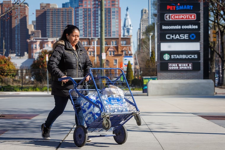 A customer at Sprouts grocery at S. Broad and Carpenter in Philadelphia buying water after a shipment arrived on Monday, March 27, 2023. The city is preparing for possible water crisis.