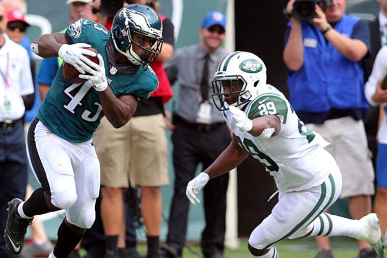 Philadelphia Eagles running back Darren Sproles (43) returns a punt for a touchdown past New York Jets running back Bilal Powell (29) during the second quarter at MetLife Stadium.